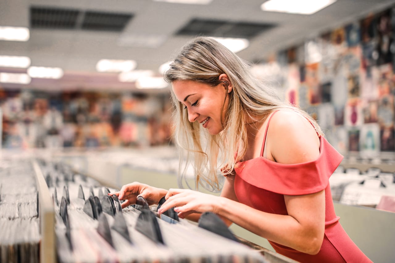 Related image woman selecting vinyls store