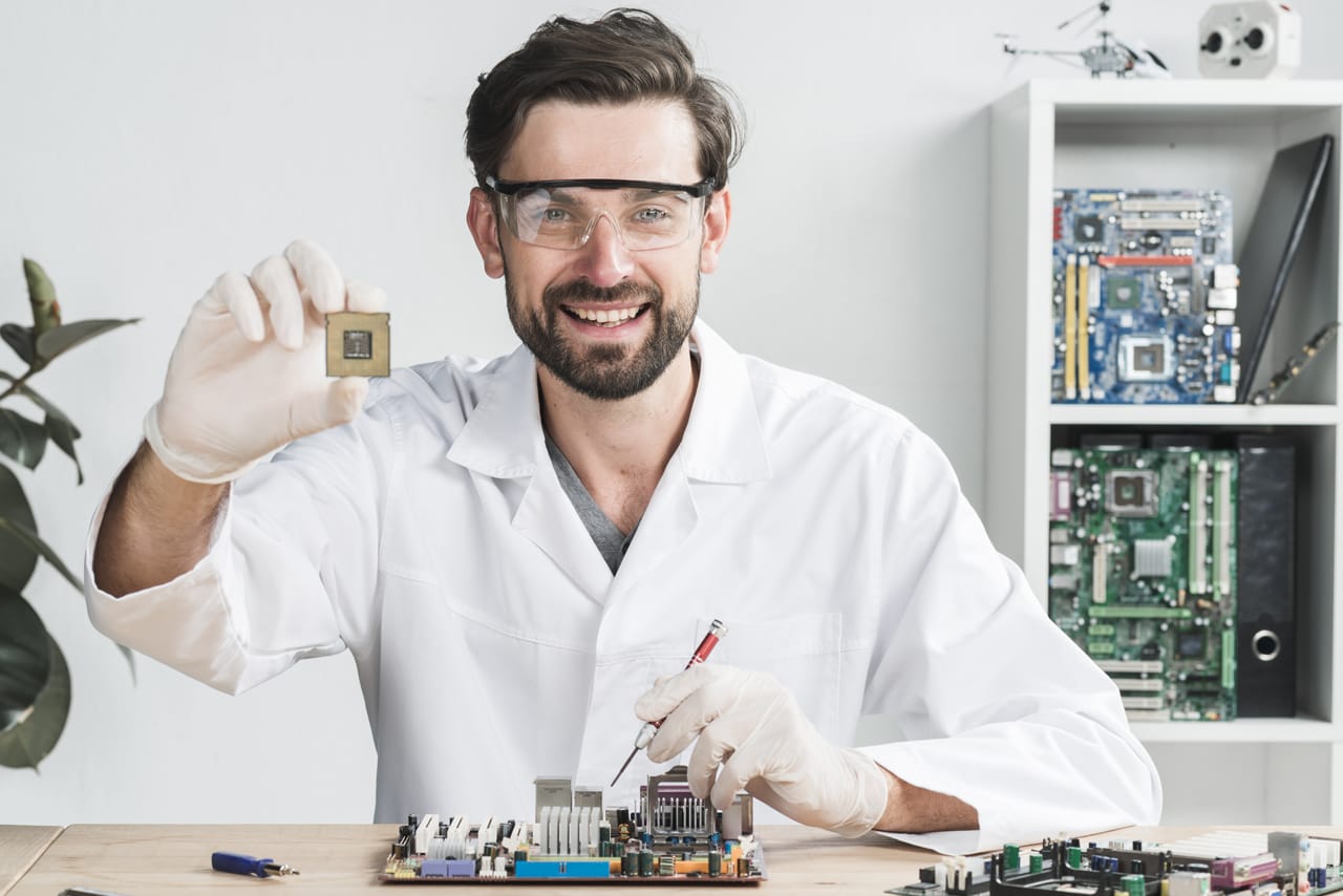 Related image portrait happy young male technician holding computer chip